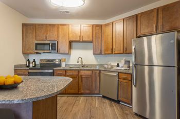 A kitchen with stainless steel appliances and granite counter tops
